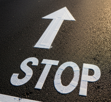 Preformed thermoplastic paint applied in the STOP word and arrow signal