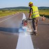 Primeroads contractor marking white paint on roads