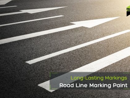 White arrows painted on asphalt point forward, with sunlight illuminating the road