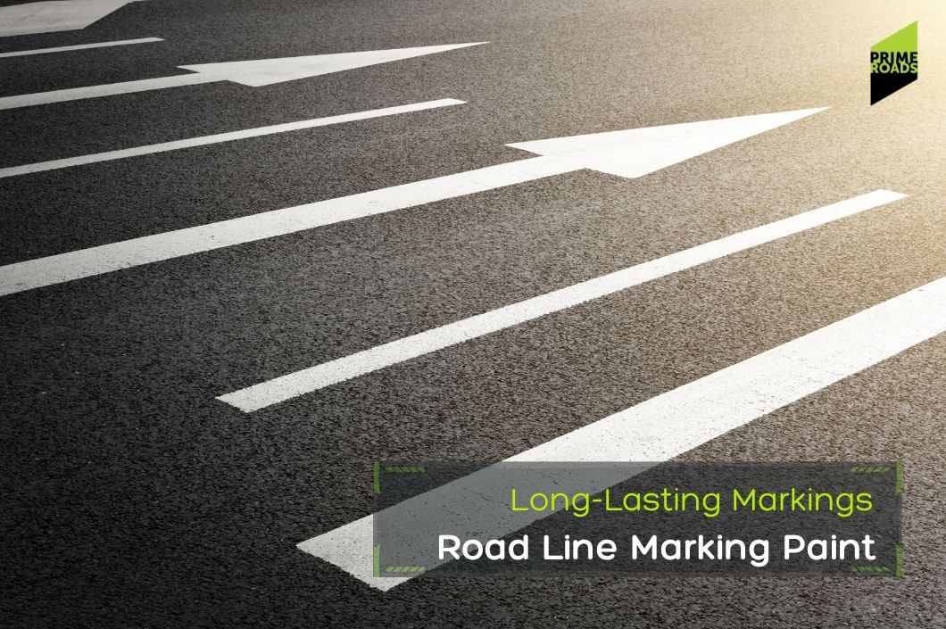 White arrows painted on asphalt point forward, with sunlight illuminating the road